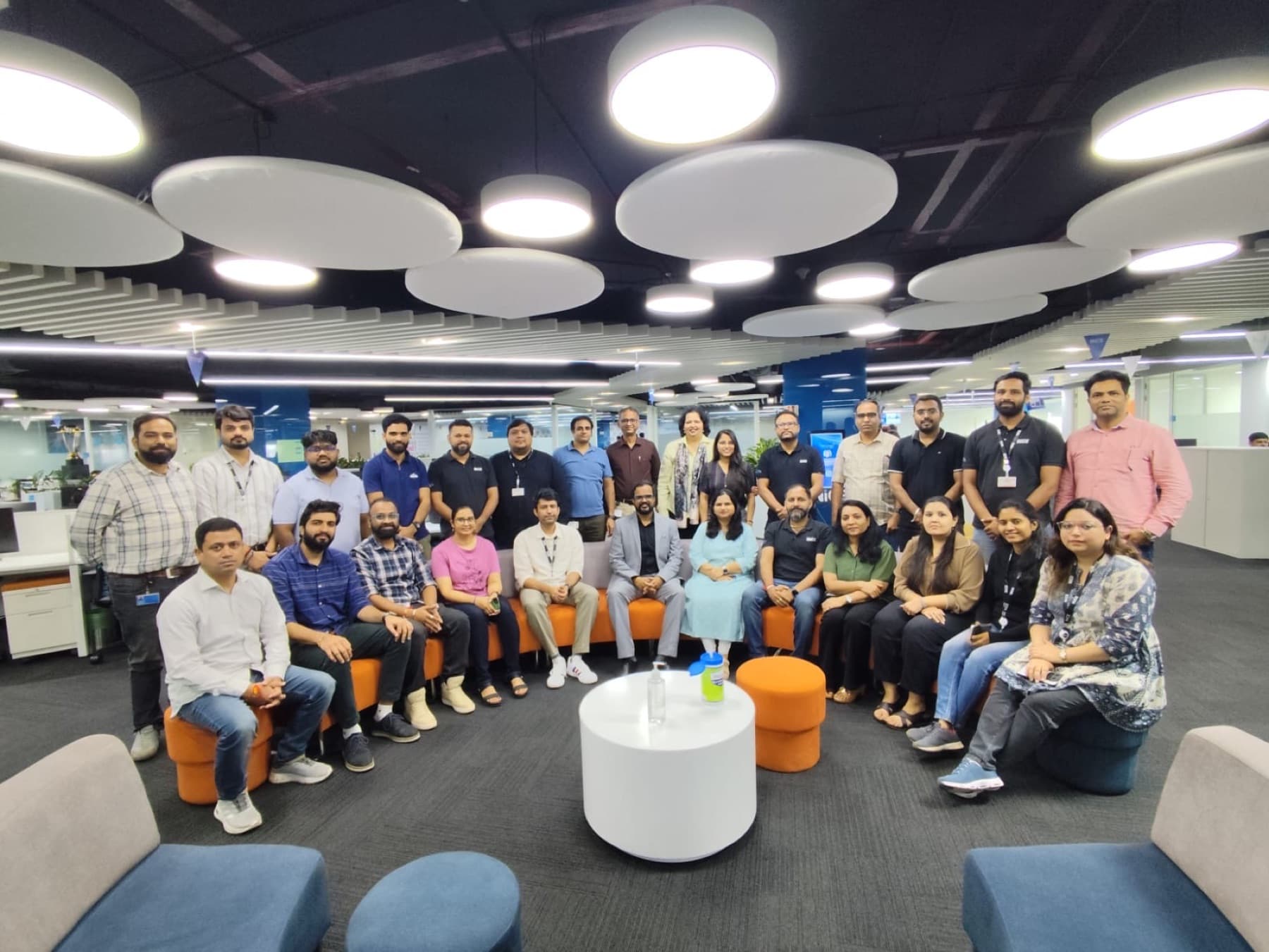 Amit Kumar Soni with a team seated in an open office lounge after a workshop.