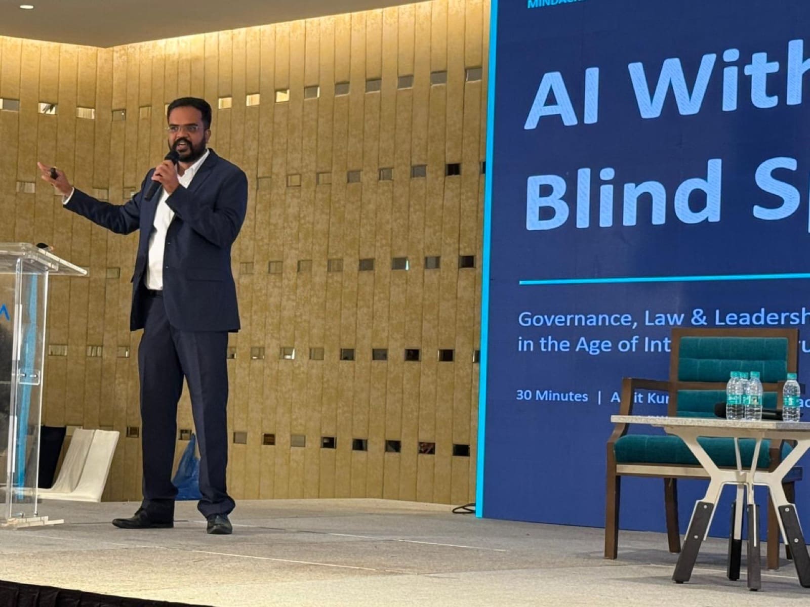 Amit addressing human-centred AI governance from a lectern.