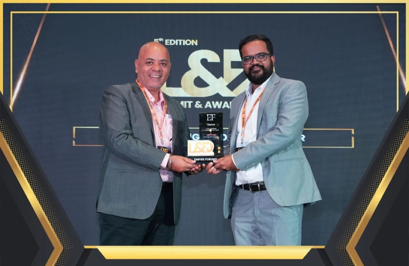 Amit Kumar Soni receiving the AI Learning Leader of the Year award from Empire Forums on stage.