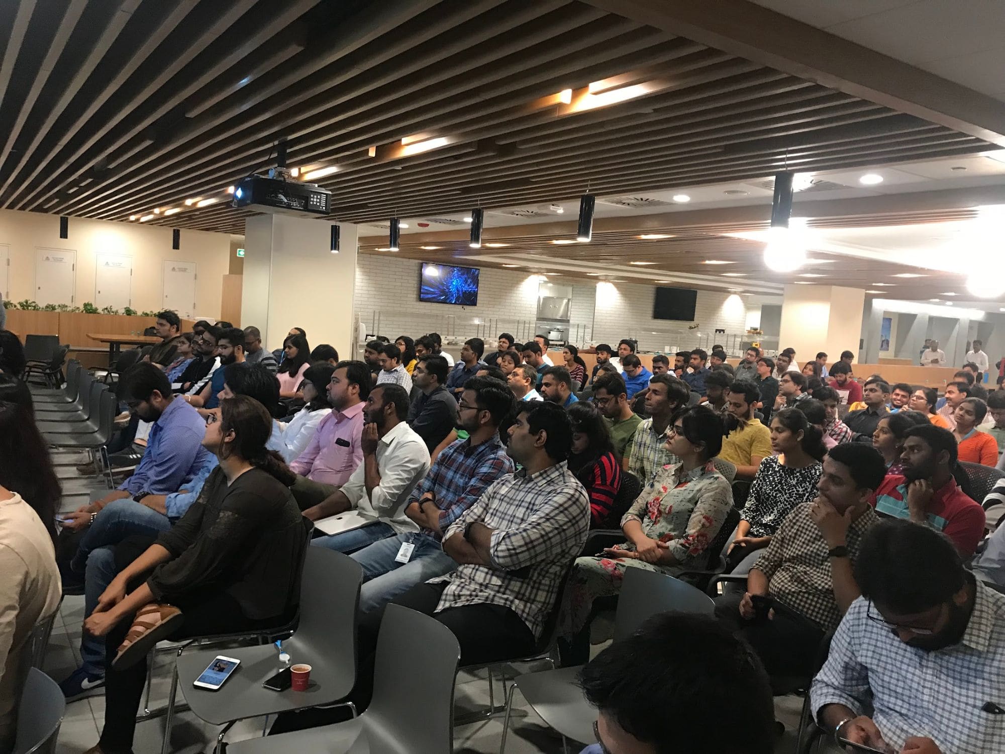 A large learning workshop or training session with many participants in an auditorium.